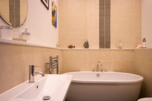High quality bathroom with shower and bath in the apartment